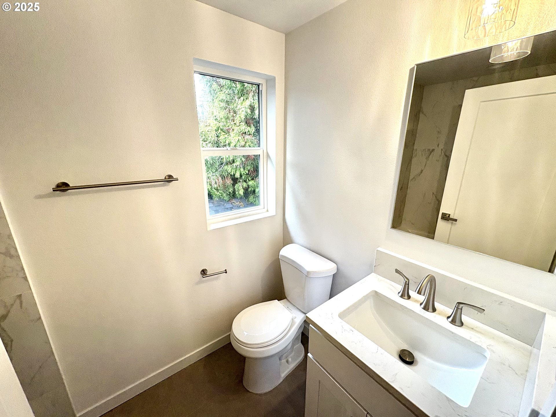 6 Northeast 74th Avenue, Unit C Portland, OR 97213 - Photo 7 of 9 a bathroom with a sink mirror vanity and toilet