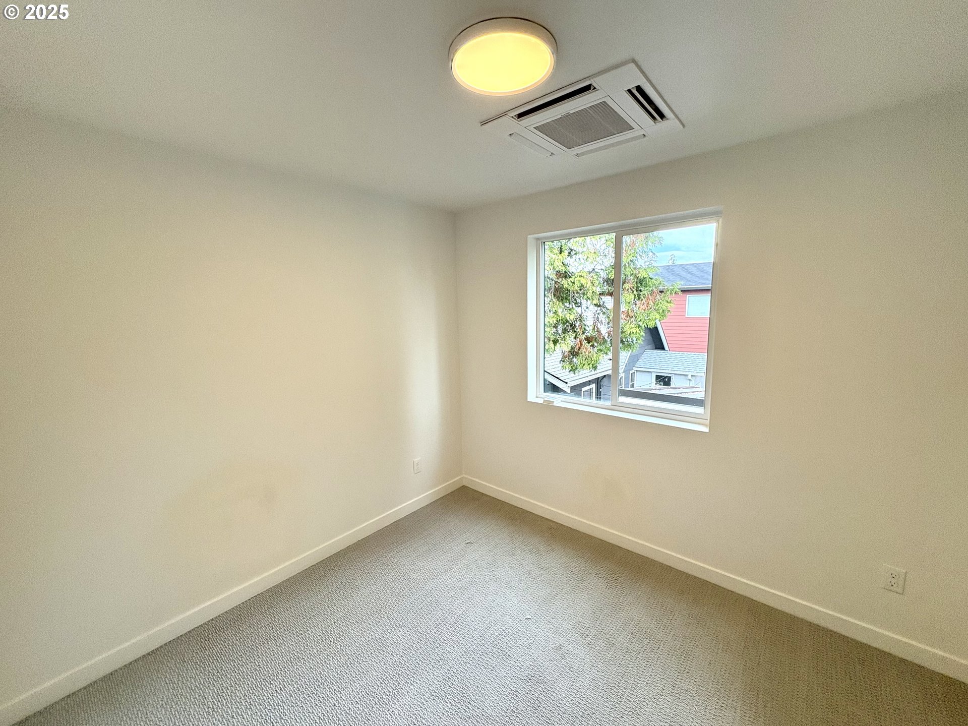6 Northeast 74th Avenue, Unit C Portland, OR 97213 - Photo 8 of 9 an empty room with windows and painted walls