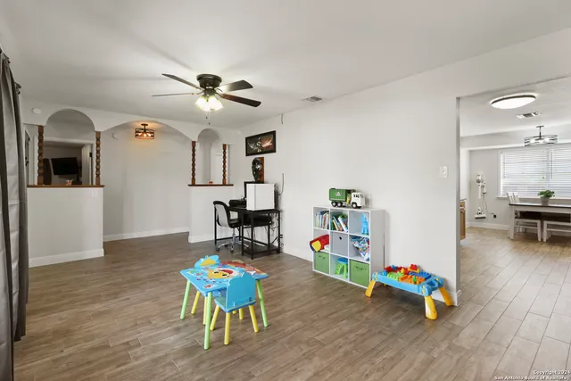 a living room with furniture and wooden floor