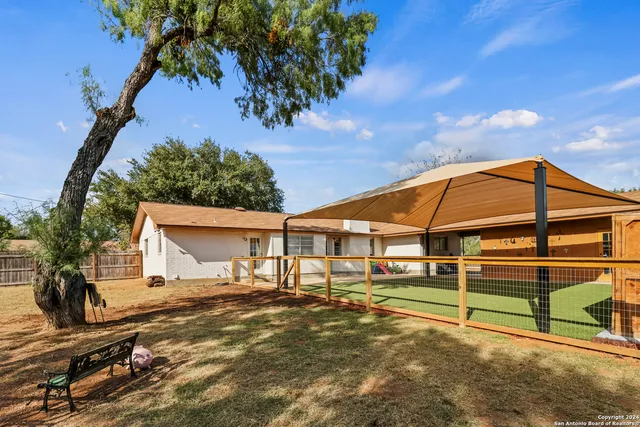 a view of a house with a backyard