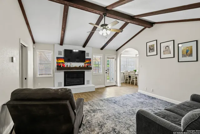 a living room with furniture and a fireplace