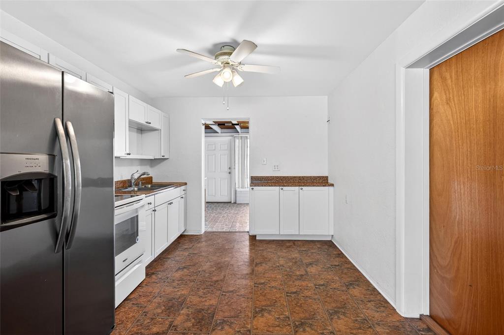 47 Carol Road Ormond Beach, FL 32176 - Photo 9 of 54 a kitchen with stainless steel appliances a refrigerator and a window