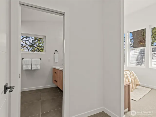 a bathroom with a double vanity sink and a window