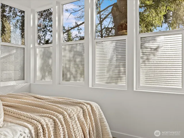 a view of room with wooden floor and windows