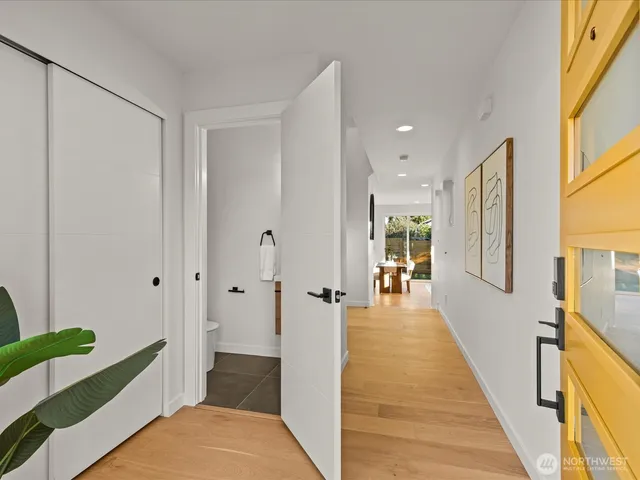 a view of a hallway with wooden floor and staircase