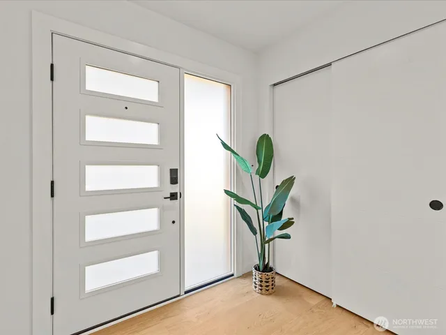 a view of living room with a potted plant on the wall and a window