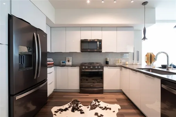 a kitchen with a refrigerator and a sink