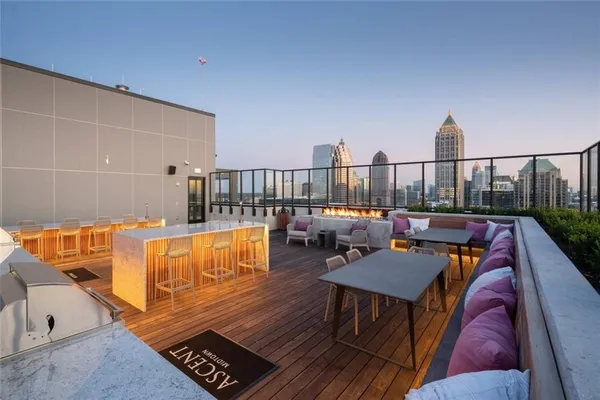a balcony with wooden floor and outdoor seating