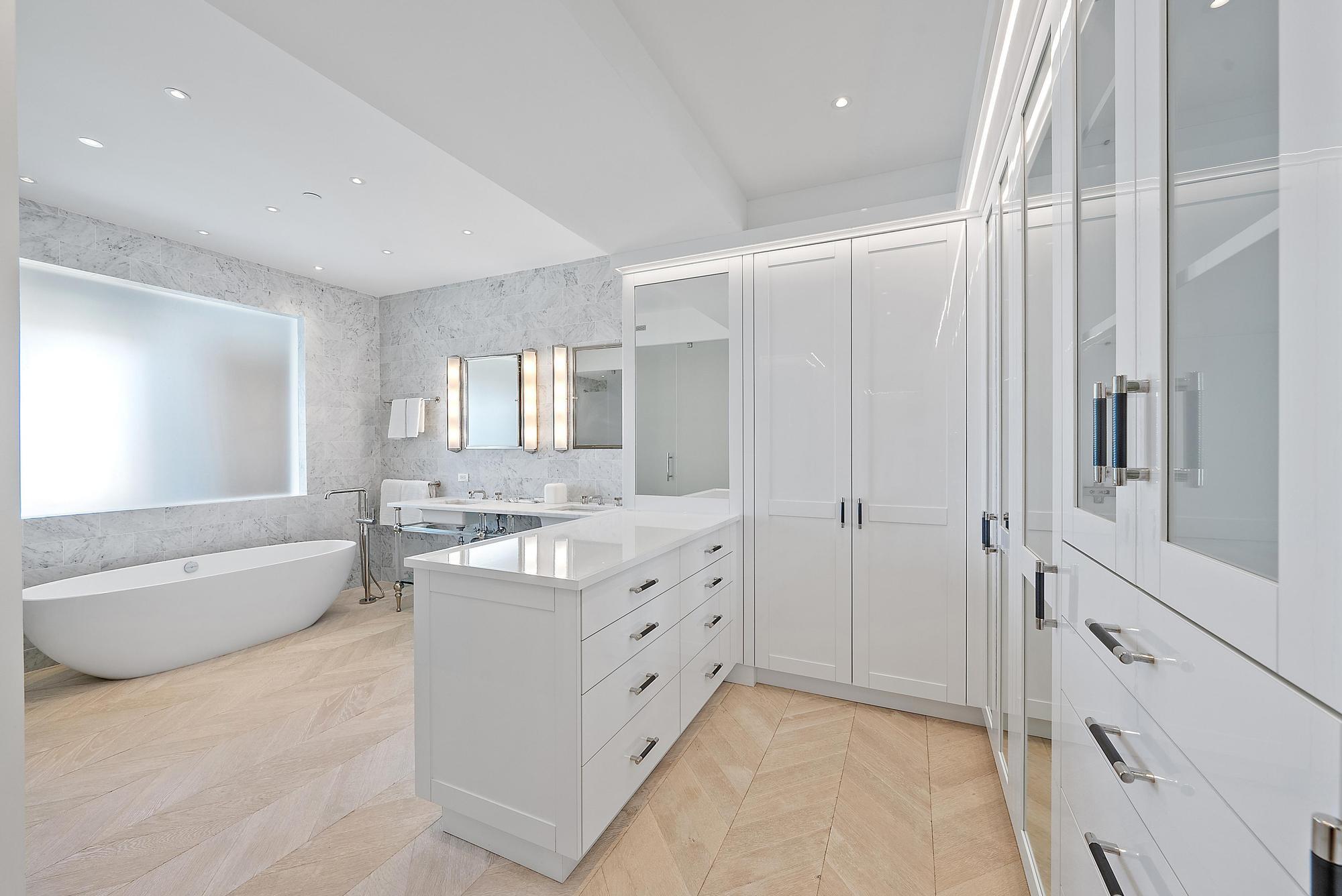 150 Bradley Place, Unit 712 Palm Beach, FL 33480 - Photo 12 of 44 a bathroom with a tub a sink and a large mirror