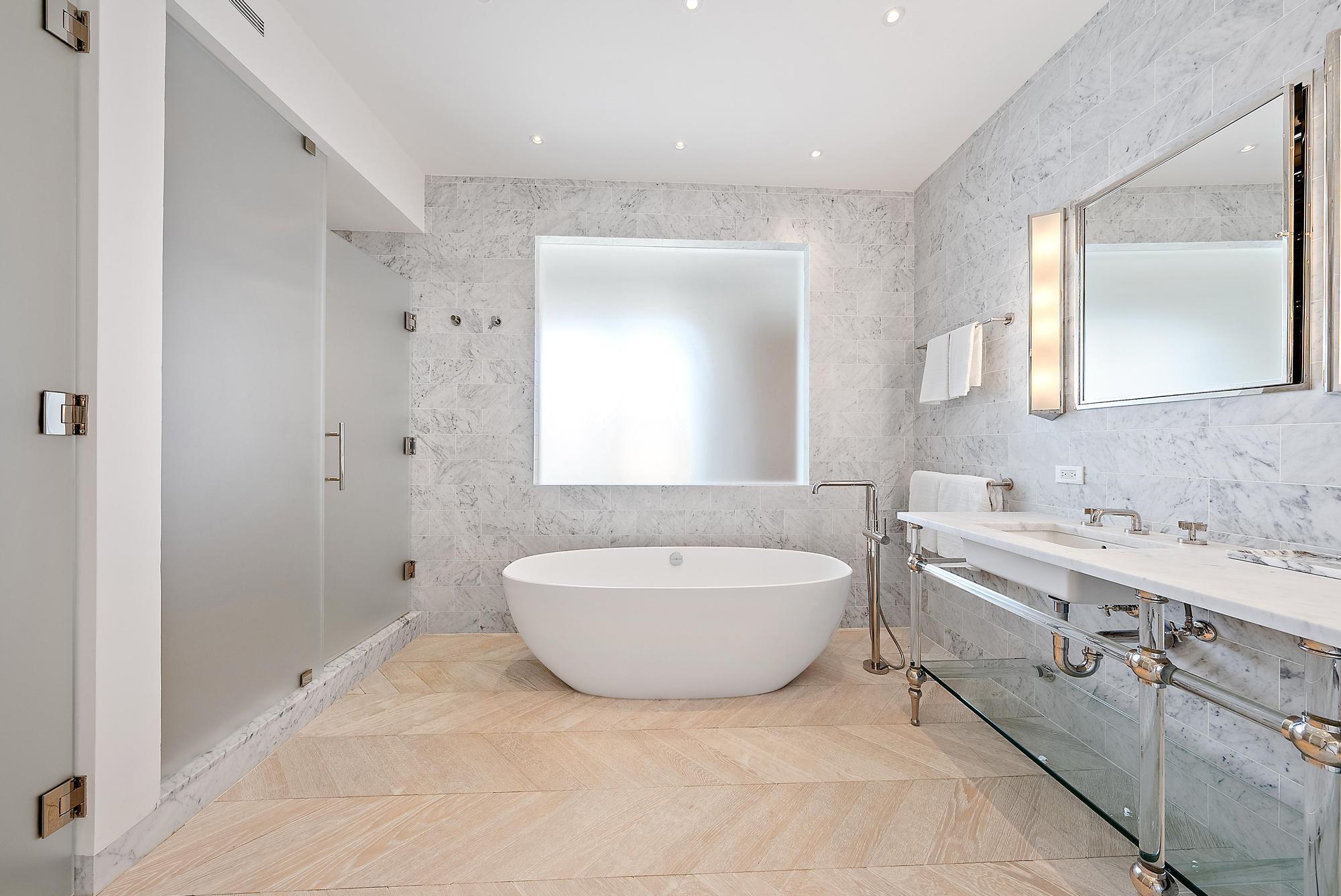 150 Bradley Place, Unit 712 Palm Beach, FL 33480 - Photo 13 of 44 a spacious bathroom with a bathtub shower sink mirror and toilet