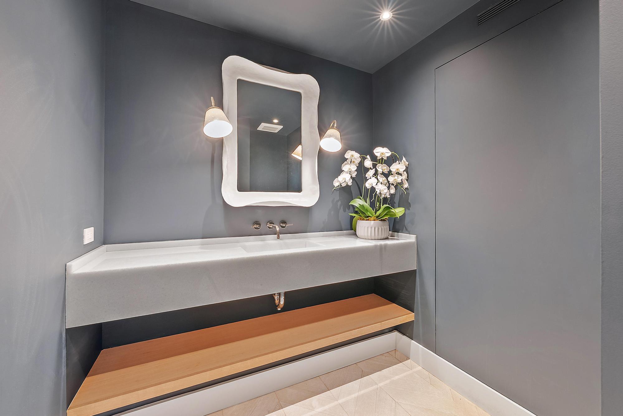 150 Bradley Place, Unit 712 Palm Beach, FL 33480 - Photo 21 of 44 a bathroom with a sink and a mirror