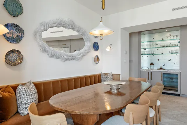 a dining room with furniture a window and wooden floor