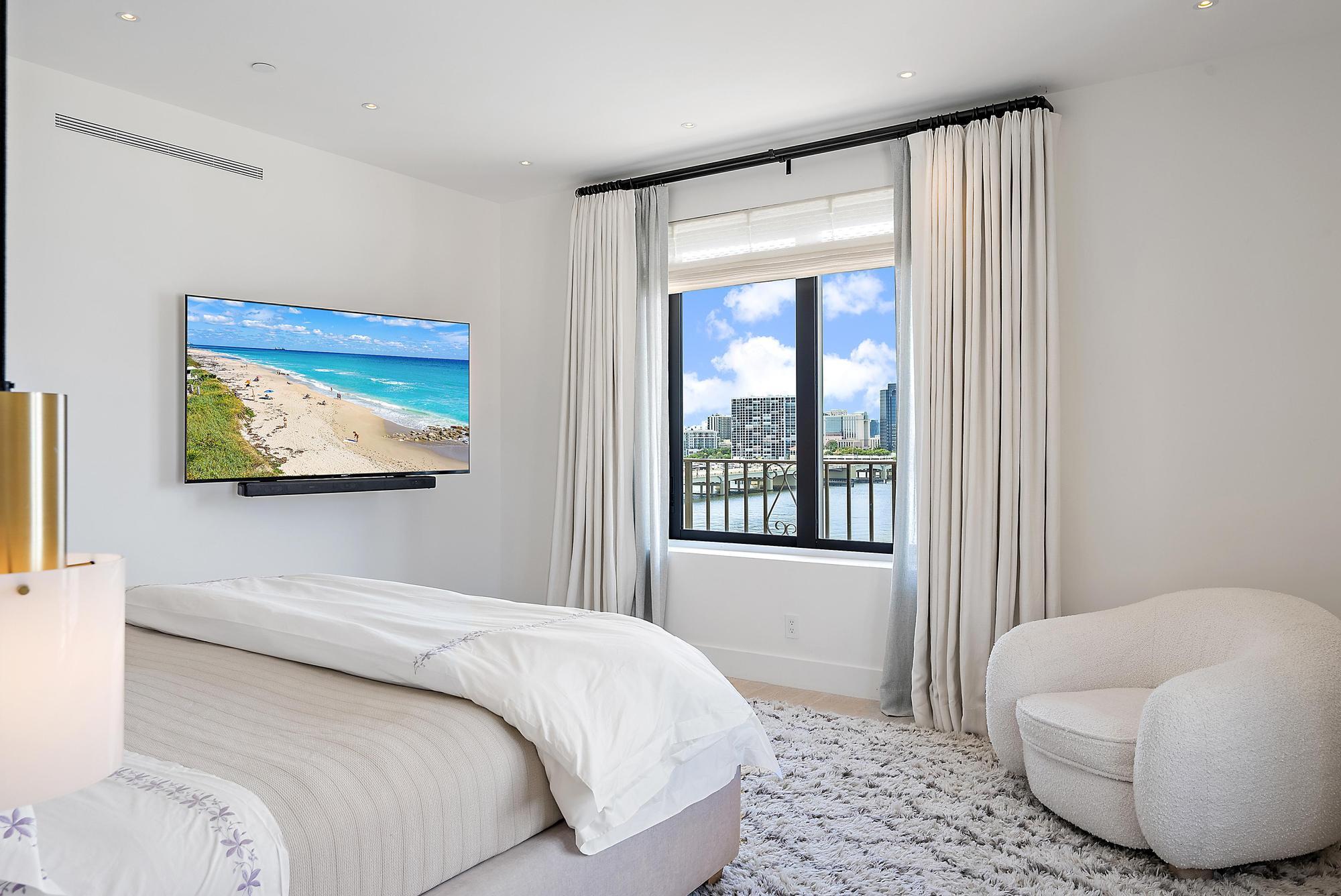 150 Bradley Place, Unit 712 Palm Beach, FL 33480 - Photo 10 of 44 a bedroom with a bed and a couch