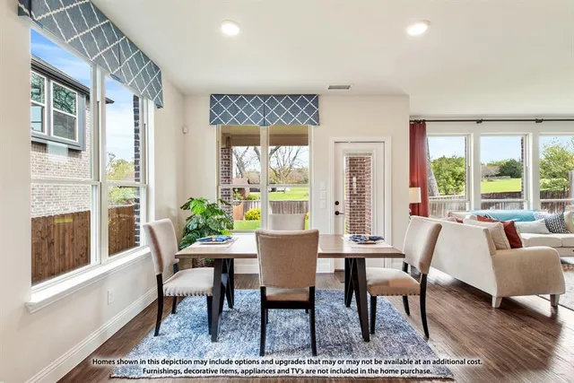 a view of a dining room with furniture a rug and wooden floor