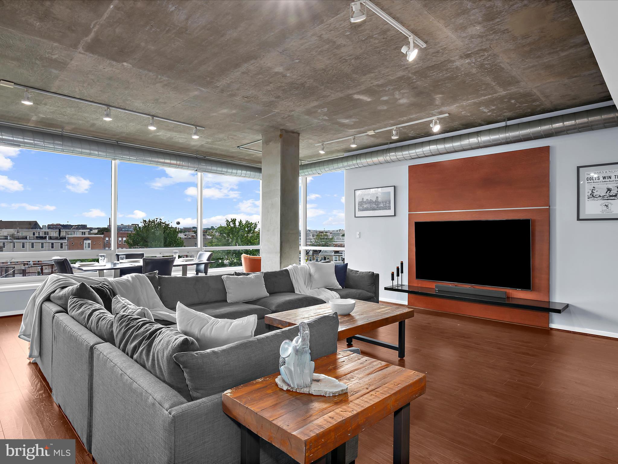 a living room with fireplace furniture and a flat screen tv