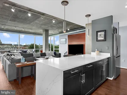 a kitchen with stainless steel appliances a sink stove and cabinets