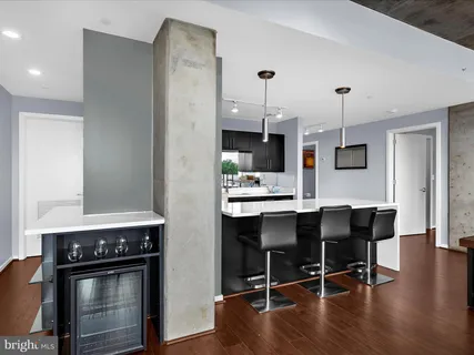 a bedroom with a large bed and a painting on the wall