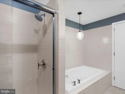 a room with wooden floor and paintings on the wall