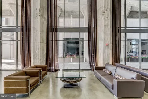 a view of a balcony with chairs and a floor to ceiling window