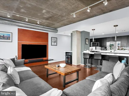 a kitchen with stainless steel appliances a dining table chairs and granite counter tops