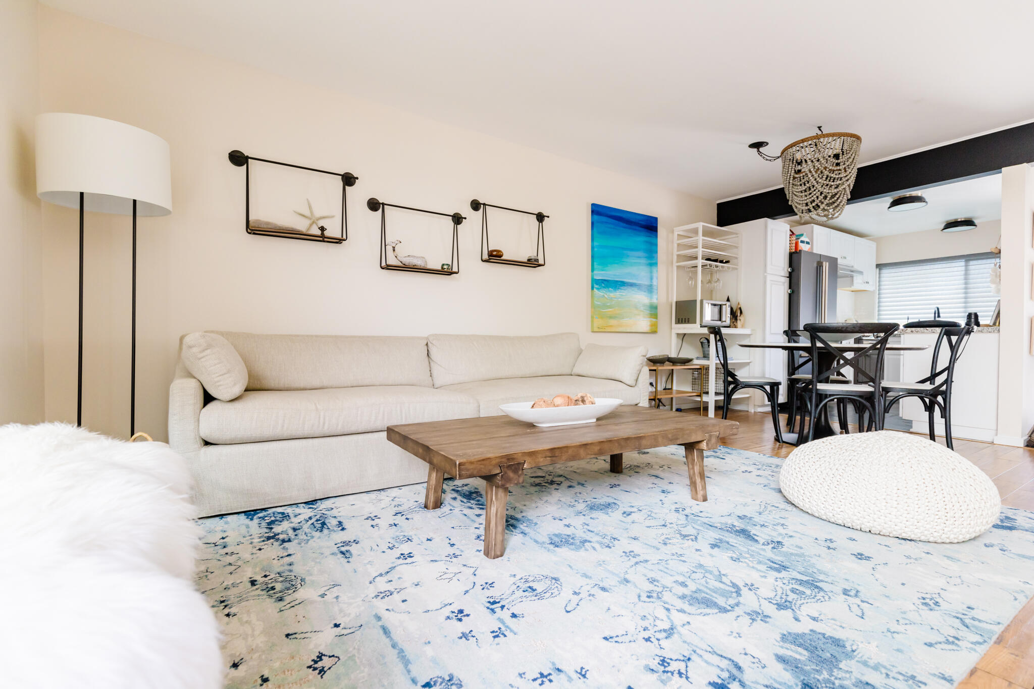 a living room with furniture a rug and white walls