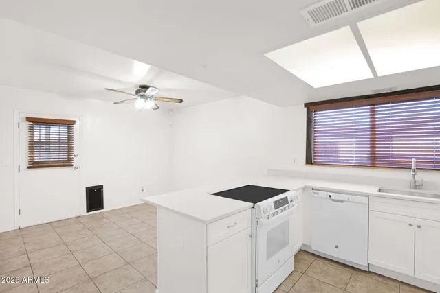 a kitchen with a stove cabinets and a refrigerator