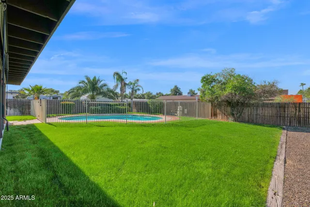 a view of a house with a yard and a patio
