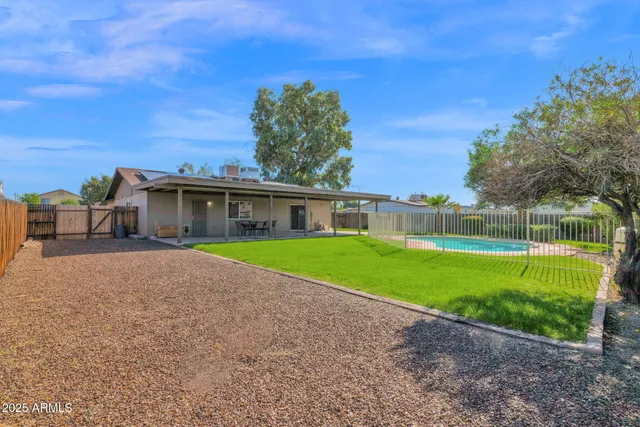 a view of a backyard with wooden fence