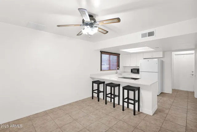 a kitchen with a table and chairs