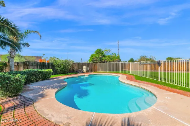 a view of a swimming pool with a yard