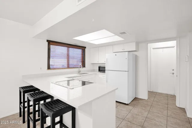 a kitchen with stainless steel appliances a refrigerator and a stove