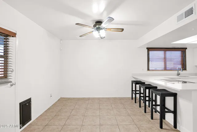 a kitchen with a table and chairs
