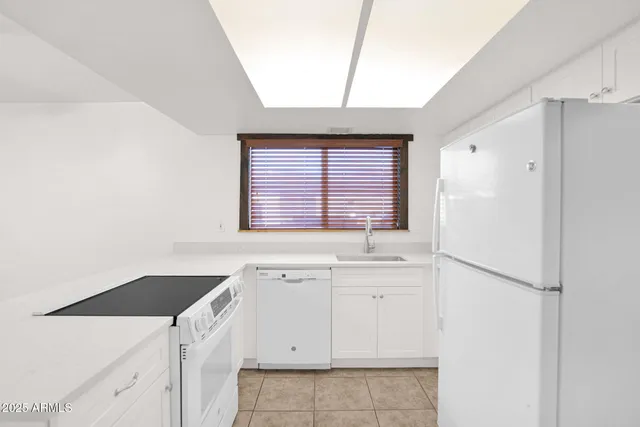a kitchen with a stove a sink and a refrigerator