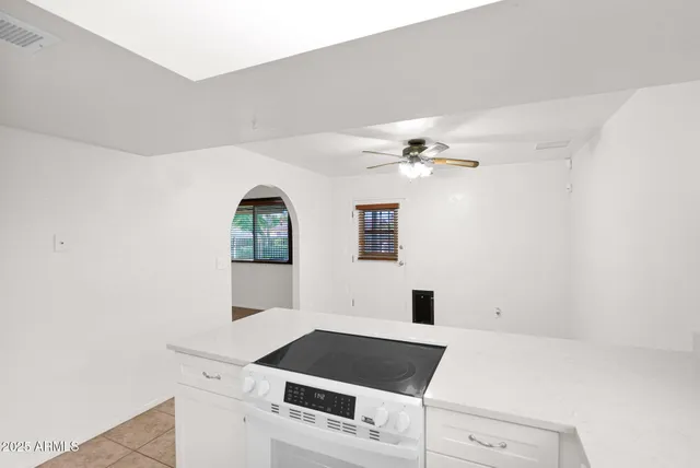 a kitchen with a refrigerator sink and white cabinets