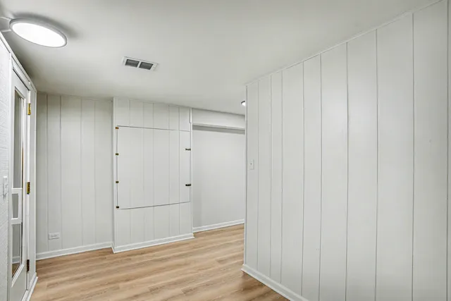 a view of hallway with wooden floor