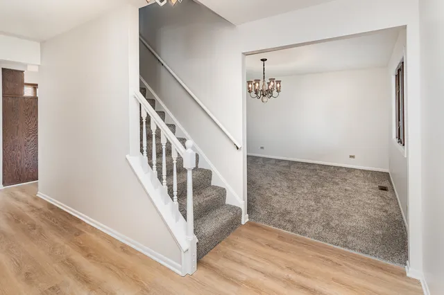 a view of an entryway with wooden floor