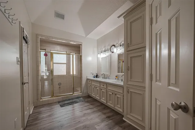 a bathroom with mirror sinks and shower