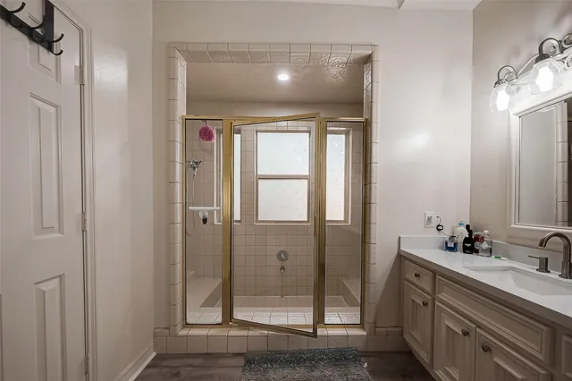 a bathroom with a double vanity sink and a mirror