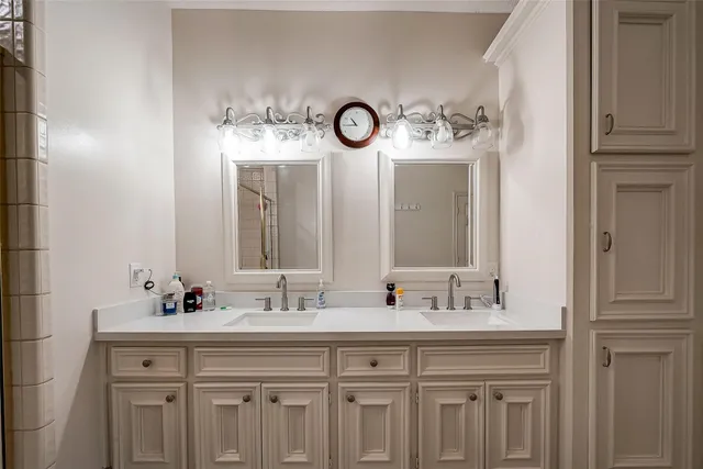 a bathroom with a double vanity sink and a mirror