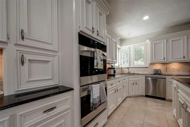 a kitchen with stainless steel appliances granite countertop cabinets and a microwave oven