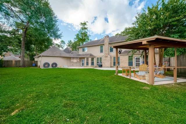 a view of a house with backyard and a patio