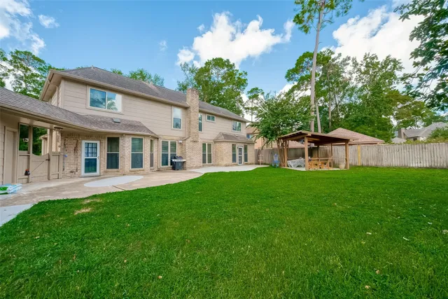a view of a house with a yard and sitting area