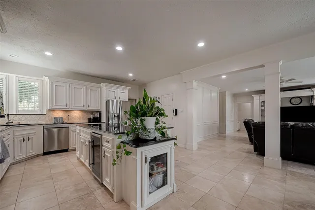 a kitchen with a sink and stainless steel appliances