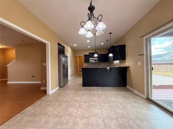 a kitchen with stainless steel appliances granite countertop a stove and a refrigerator