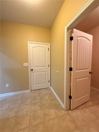 an empty room with a window and a ceiling fan