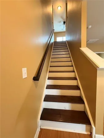 an empty room with windows and chandelier fan