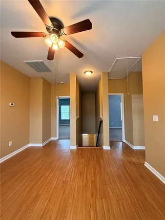 a view of a livingroom with a ceiling fan and window