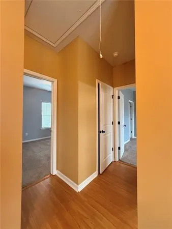 a view of a hallway with wooden floor