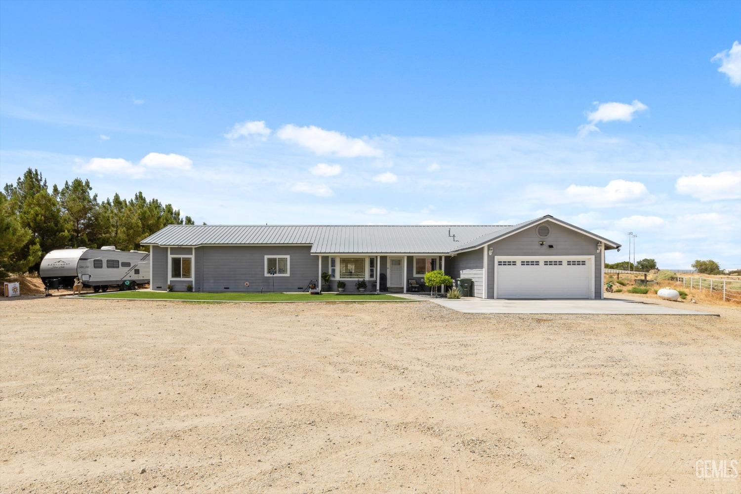Undisclosed Address Maricopa, CA 93252 - Photo 13 of 47 a front view of a house with a yard