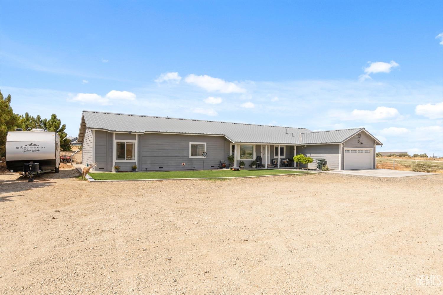Undisclosed Address Maricopa, CA 93252 - Photo 14 of 47 a front view of a house with a yard and garage